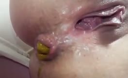 Close up of shaved babe shitting