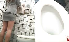 Curvy brown haired teen using public toilet